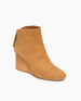 Coclico Lovage Boot in Wheat suede, angle view: Sculpted 75mm solid wood wedge with a rounded toe and a back zip closure.  3