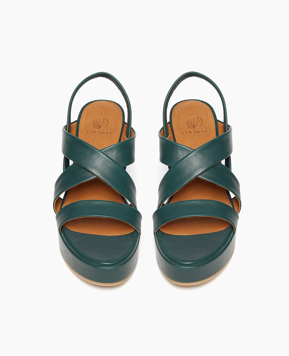 Top view: Coclico Lylo Wedge in Riviera Green leather: leather wrapped cork wedge, crisscrossed straps across foot, elasticated slingback strap.