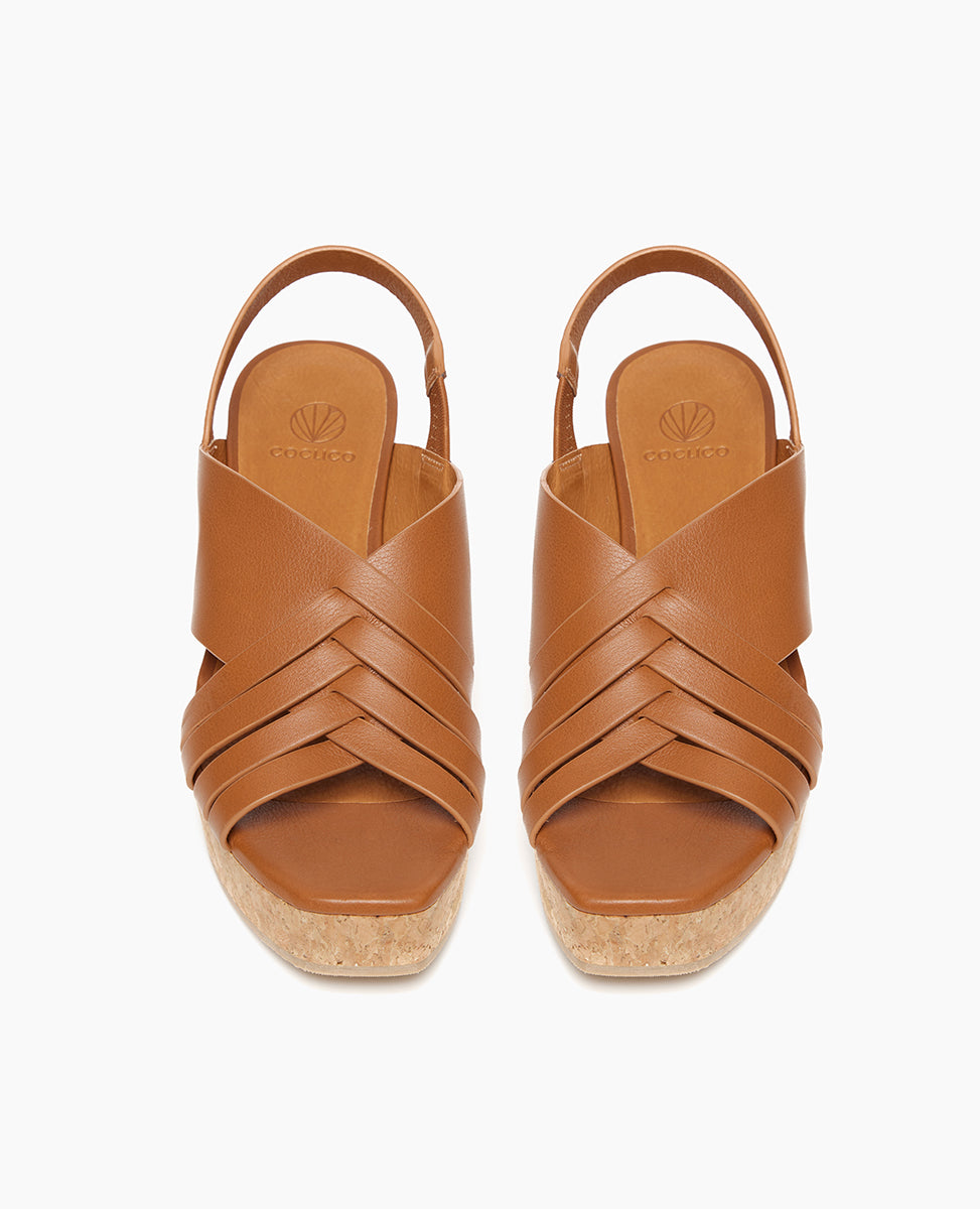 Top view of Coclico Moska Wedge in Cuoio leather a Huarache inspired cork wedge with a woven leather band across foot, slingback strap. 