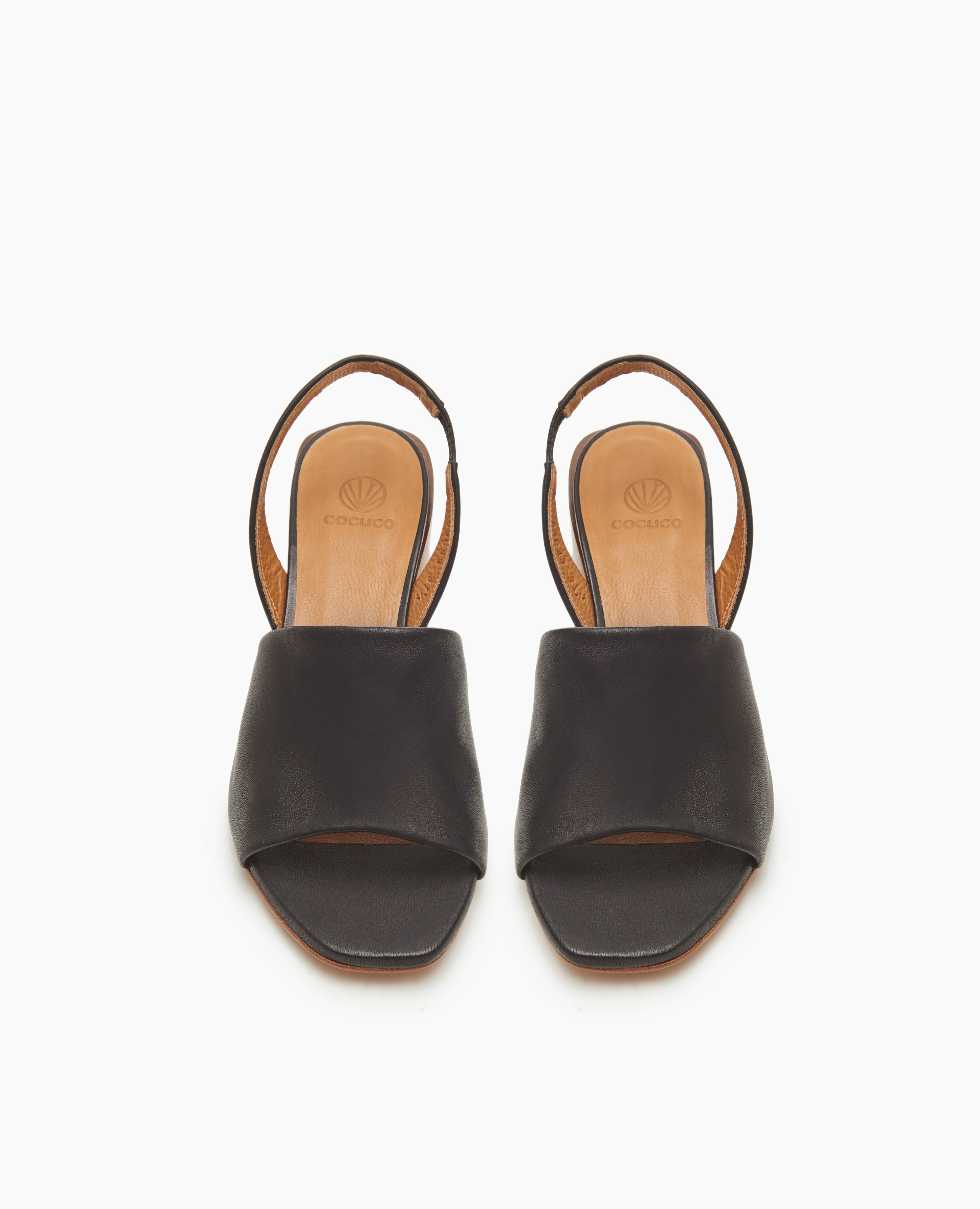 Coclico Okolo Sandal in Black leather: slingback sandal with wide stretch leather band across the foot and softly curved, low, solid wood heel - top view.