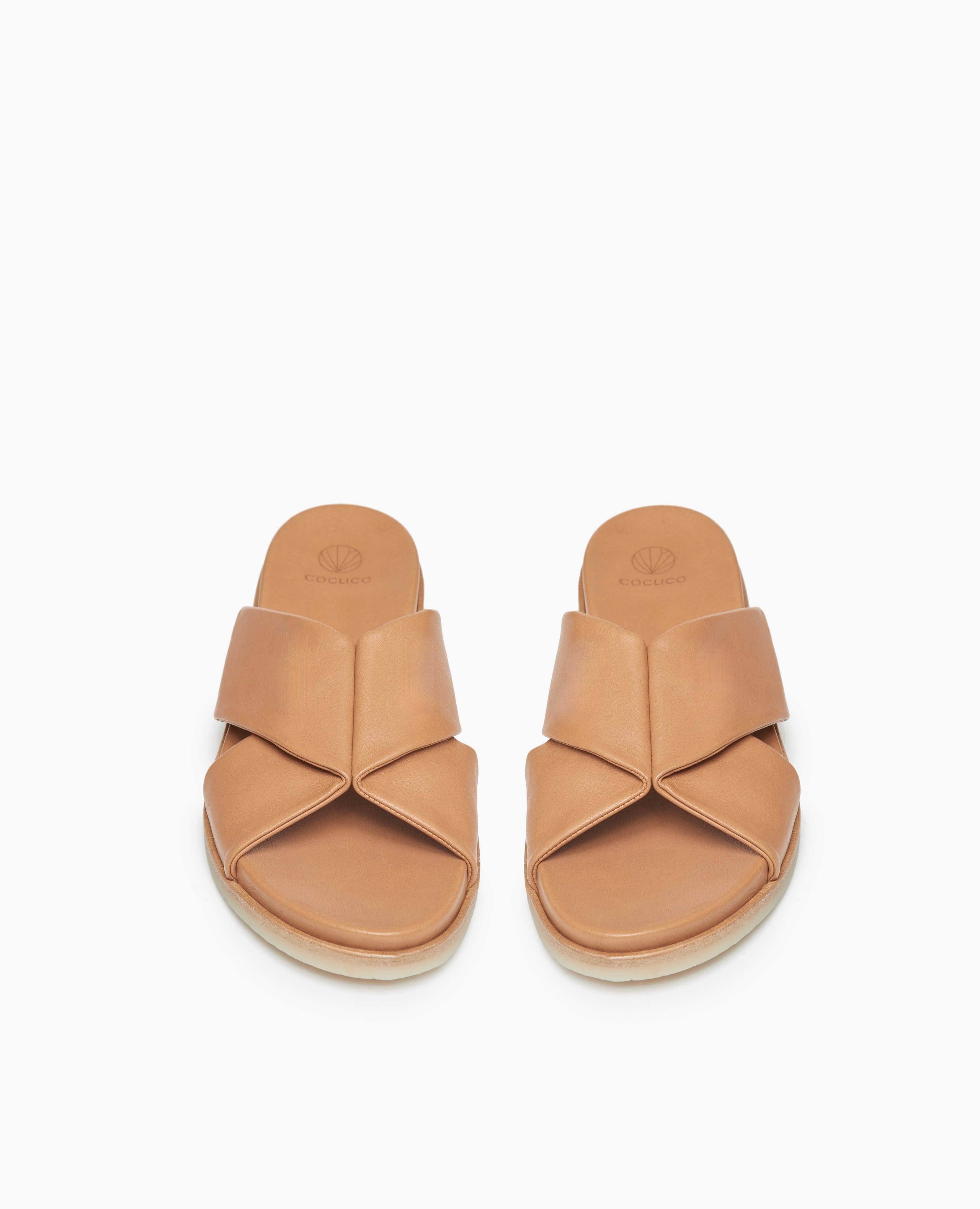 Top view: Coclico Pasque Sandal in Mandorla  leather:a low pine wedge slide sandal, intertwined leather tube straps across foot, gum-rubber sole.