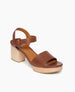 Angle view: Coclico Riviera Clog in Cuoio leather: quarter-strap, wide front band, buckle closure, with a solid wood platform to match the solid wood mid-height heel. 5