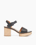 Coclico Riviera Clog in Deep Sea leather, side view: wide front band, quarter-strap, buckle closure, with a solid wood platform to match the solid wood mid-height heel. 1