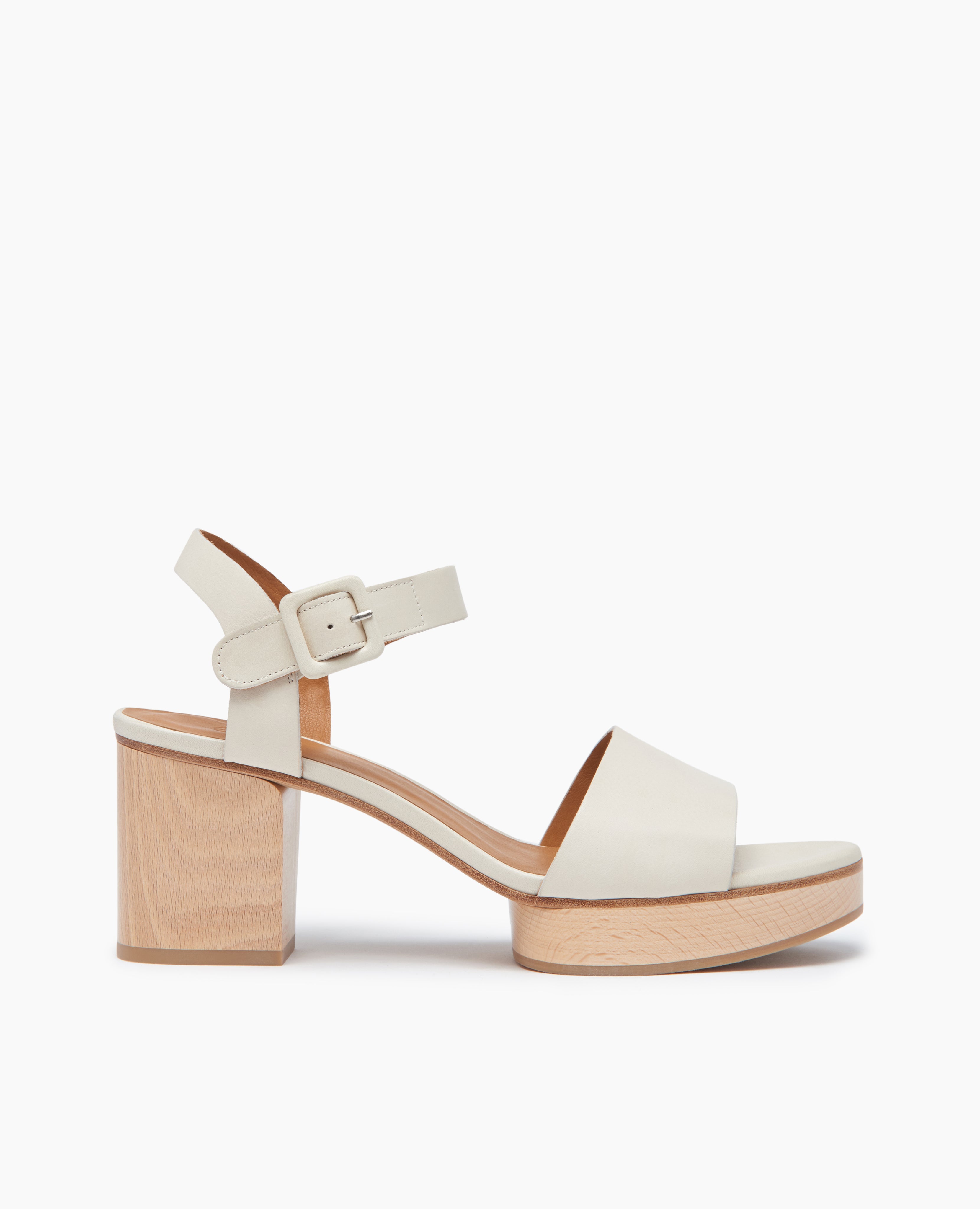 Side view Coclico Riviera Clog in Greige (off-white) leather: quarter-strap, wide front band, buckle closure, with a solid wood platform to match the solid wood mid-height heel.