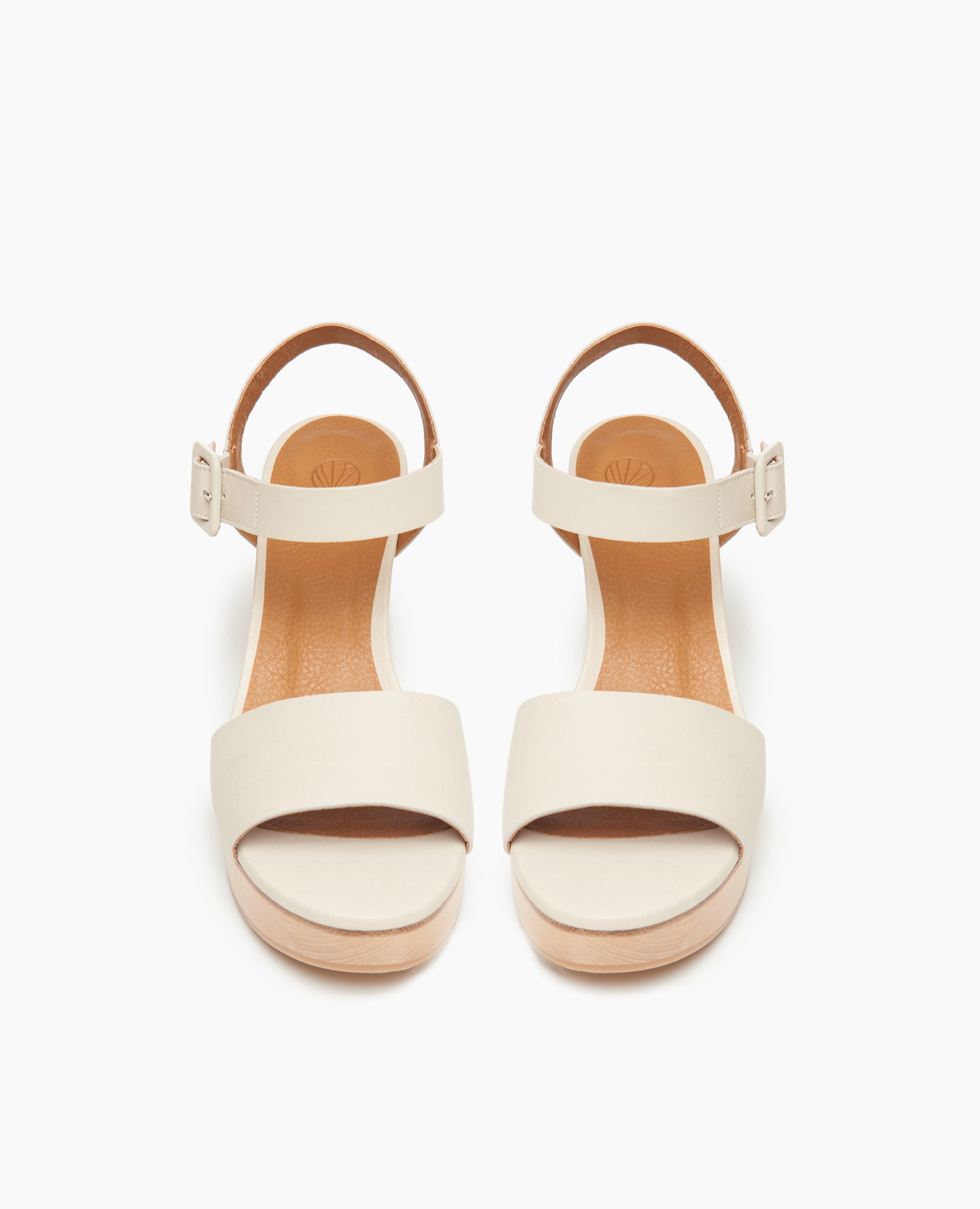 Top view: Coclico Riviera Clog in Greige (off-white) leather: wide front band, quarter-strap, buckle closure, with a solid wood platform to match the solid wood mid-height heel.