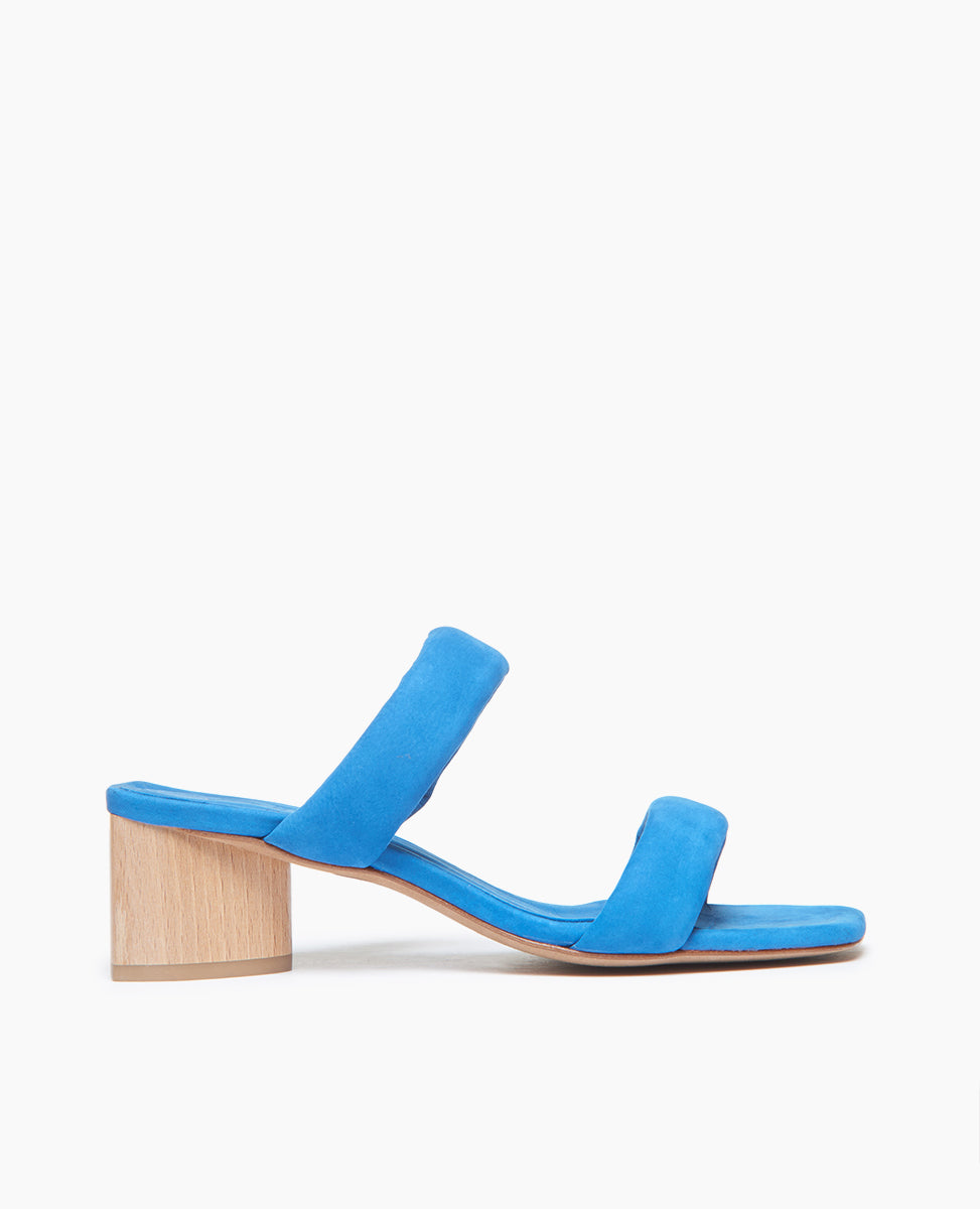 Coclico Sofiya Heel in Blu Reale nubuck: a slide-on sandal with a low-height solid wood triangular heel, two padded leather straps across foot, angular toe and heel design - side view. 