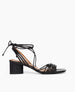 Side view of the Coclico Solomiya Heel in Black leather a gladiator-style sandal, thin leather straps across vamp of foot, low-height solid-wood angular black heel. 1