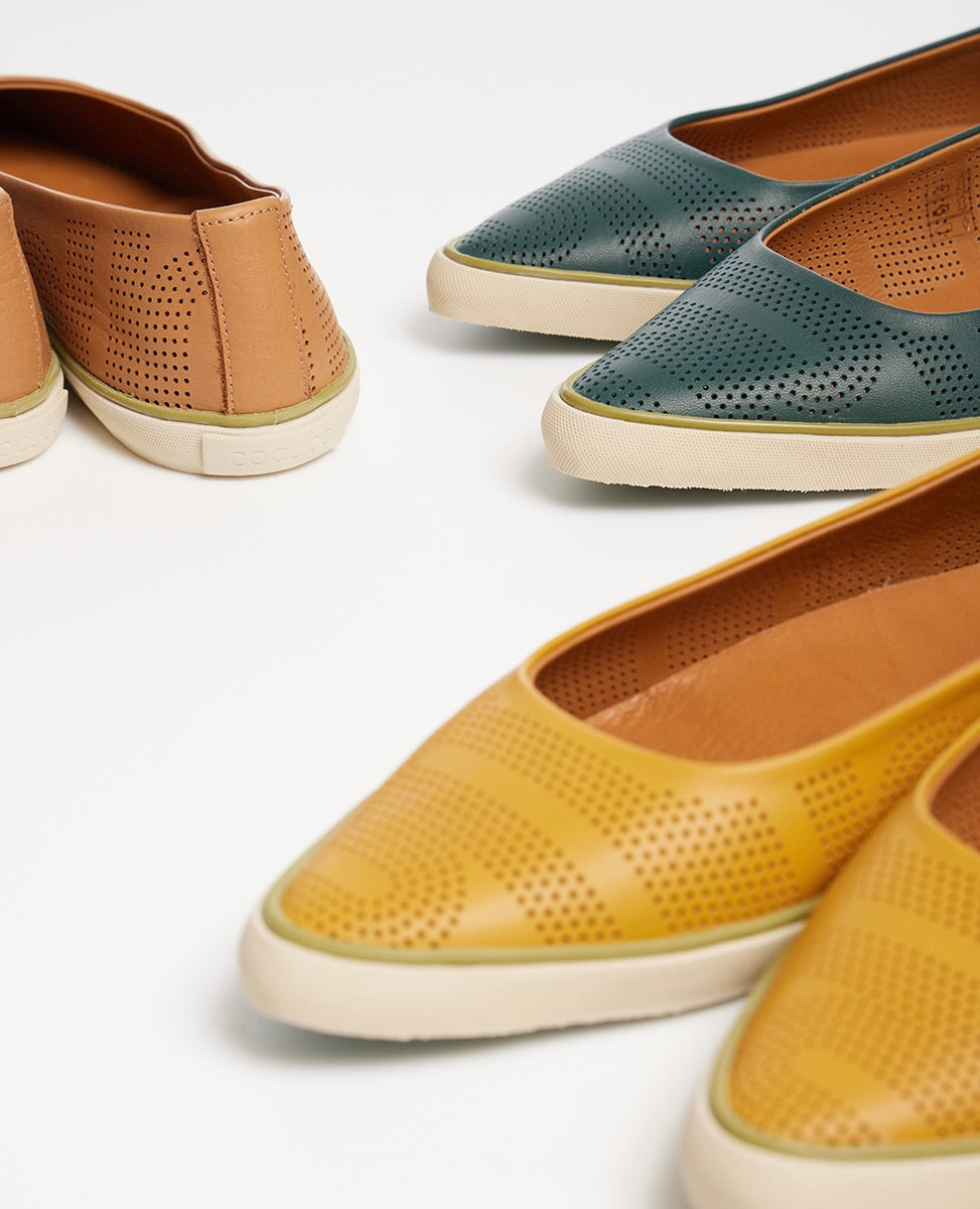Close up of the pointed toe and Coclico logo on the heel of the Usha Sneaker.