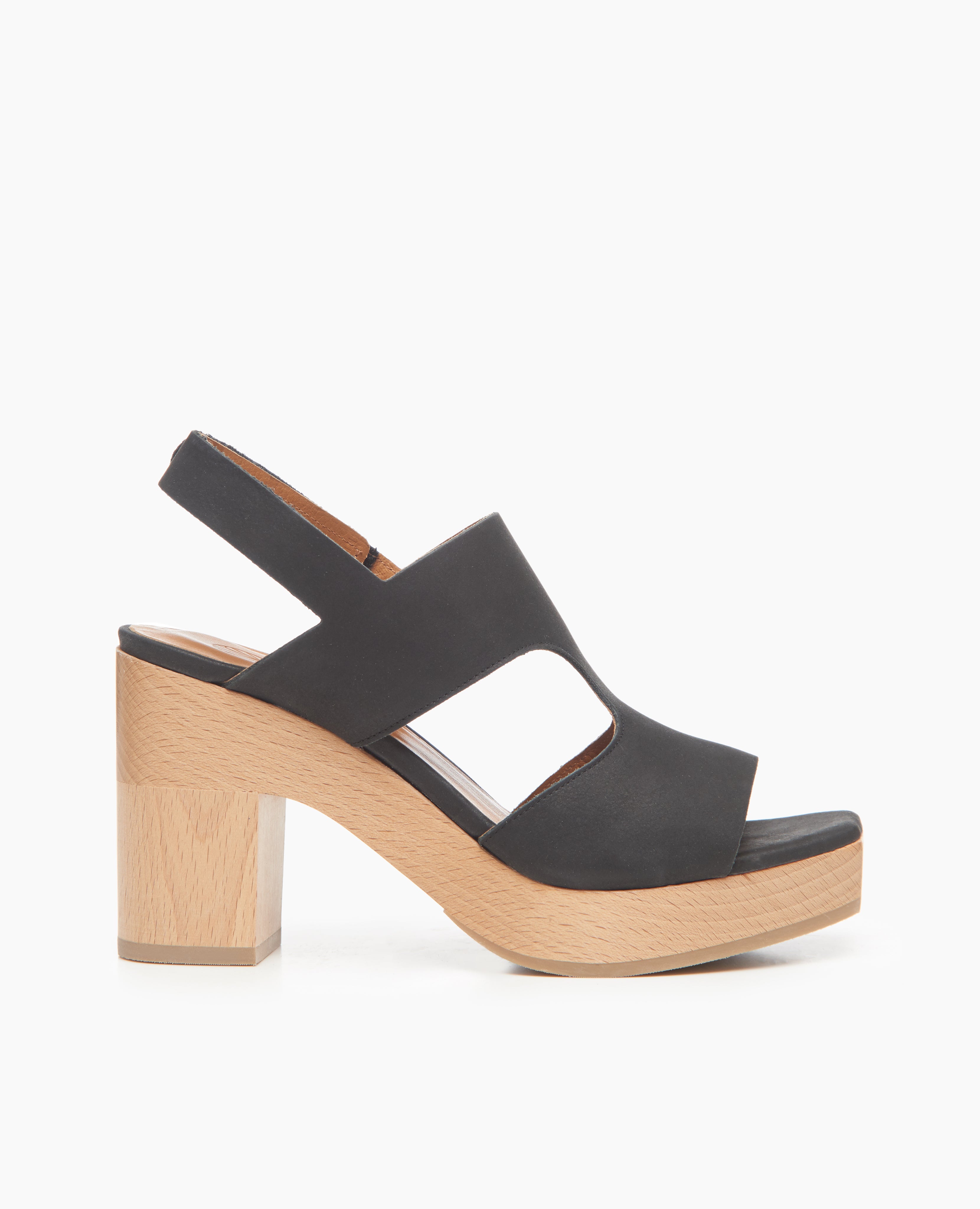 Side view: Coclico Vicky Clog in Black leather: a t-straped clog, arched openings, angular toe, round heel, tall-height solid wood base.