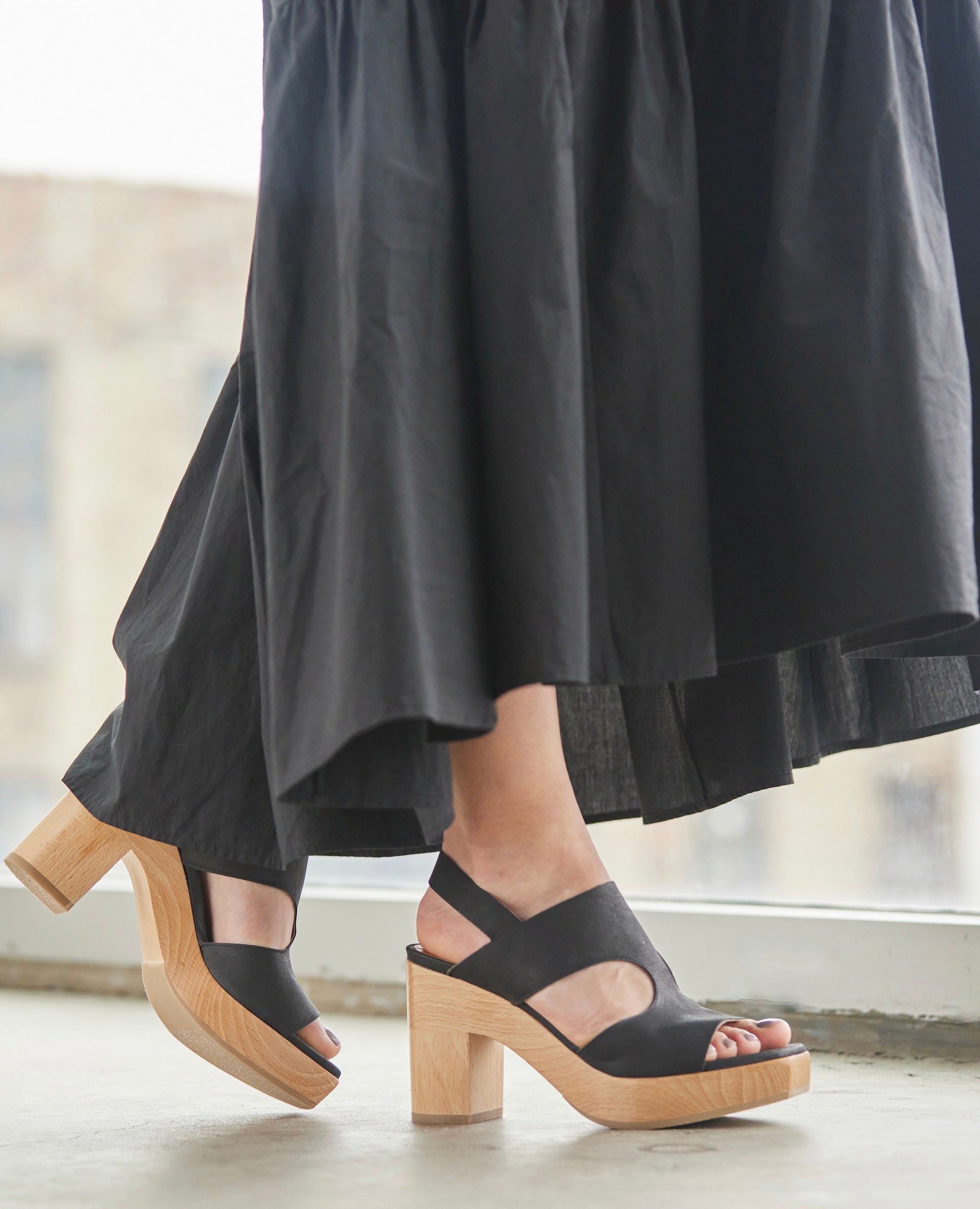 Model walking in Coclico Vicky Clog in Black leather.