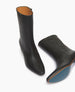 Front view of one Wakame Boot in Black Leather standing with the other on its side.  11