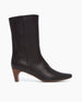 Side view of the Wakame Boot in Black Leather: a sophisticated snip-point-toe boot with an arched wood heel.  Inside zip closure.  1