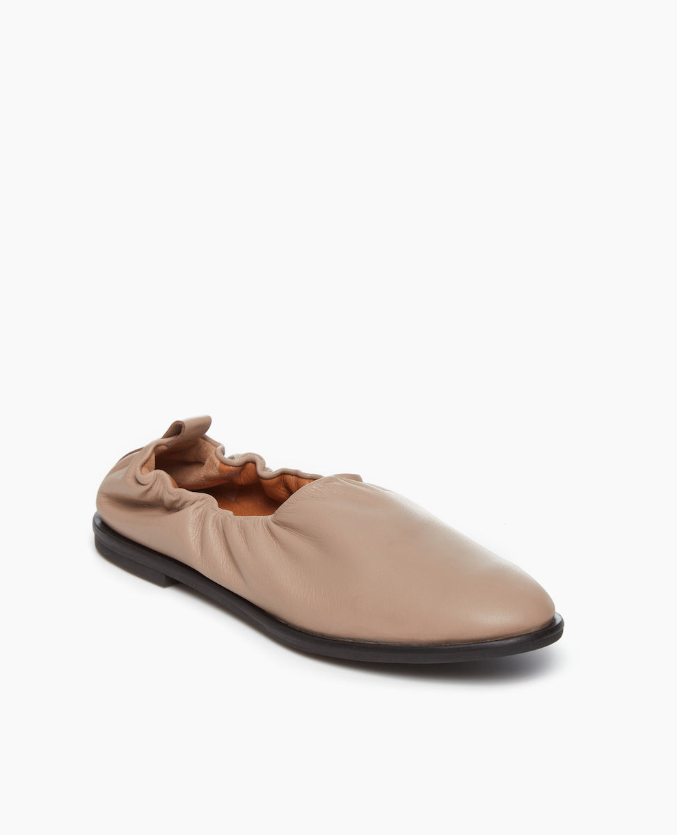 Angled view of the Grey Mist Leather: a classic high-vamped, slip-on flat.