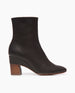 Side angle of mid calf black boot with wood heel and hidden wedge. 1