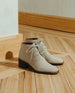 Sunlit, close up side view shot of the Coclico Sake Boot in Siberia (cream) cord suede - on wood flooring.  4