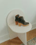 Coclico Vanji Clog in Anthracite suede - displayed on white arched design stool with a side view.  2