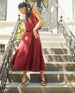 Full body shot of model on steps wearing Coclico Diana Wedge in Black leather: Open wedge with tubular leather straps across the foot, slingback heel strap, solid wood mid-height wedge. 6