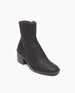 Coclico Franna Boot in Black leather, a mid-height solid wood block black heel, stepped topline, squared-off toe, scored rubber sole and an inside zip closure - angle view.  2