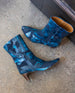Coclico Wakame Boot in Painter's Blue against a stone floor.  2