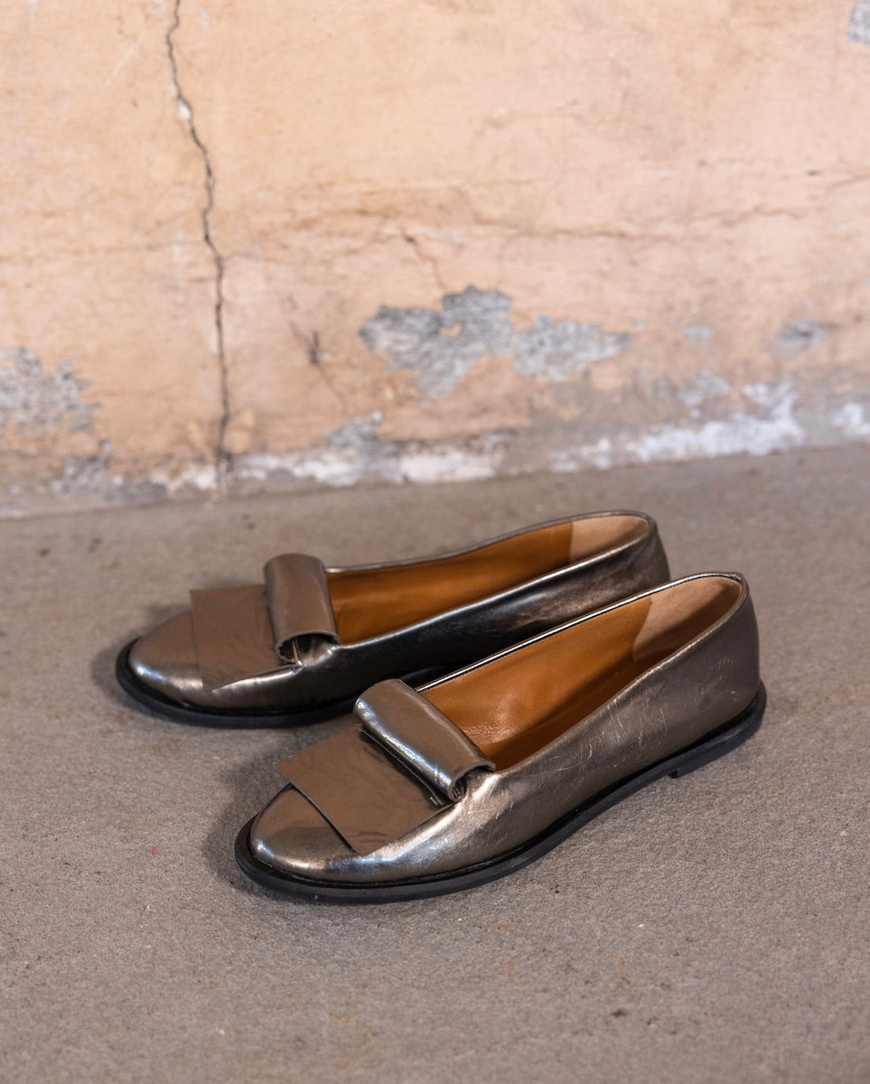 Yale Loafer in Starry Night against a stone wall.