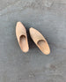 The Coclico Kule Clog in Latte nubuck on concrete flooring - top view.  4