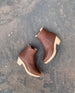 Coclico Keep Shearling Clog Caramello leather - top view shot with terracotta wall in background. 2