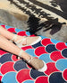 Legs of a model wearing the Kashm sneaker crossed on a colorful lounge chair. 6