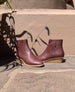 Coclico Java Boot in Merlot leather displayed on stone flooring in sunlight.  5