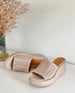 Coclico Laleh Wedge in Grey Mist (Marmo) leather perfed a slide-on cork wedge covered in padded leather with pinhole strap across foot - displayed on table with decor.  7