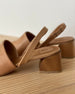 Close up of Coclico Okolo Sandal in Mandorla leather slingback heel and softly curved, low, solid walnut wood heel.  4