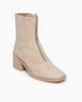 Angle view of Coclico Furin Boot in Latte nubuck: a mid-calf height boot with front zipper closure,  leather pull tab,  scored rubber sole and a mid-height solid wood block heel.  5
