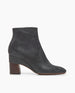 Lono Boot in Prismanet Black leather, side view: a textured leather wrapped demi-wedge boot with an inside zip closure, leather sole and a mid-height, gently curved solid wood heel.  1